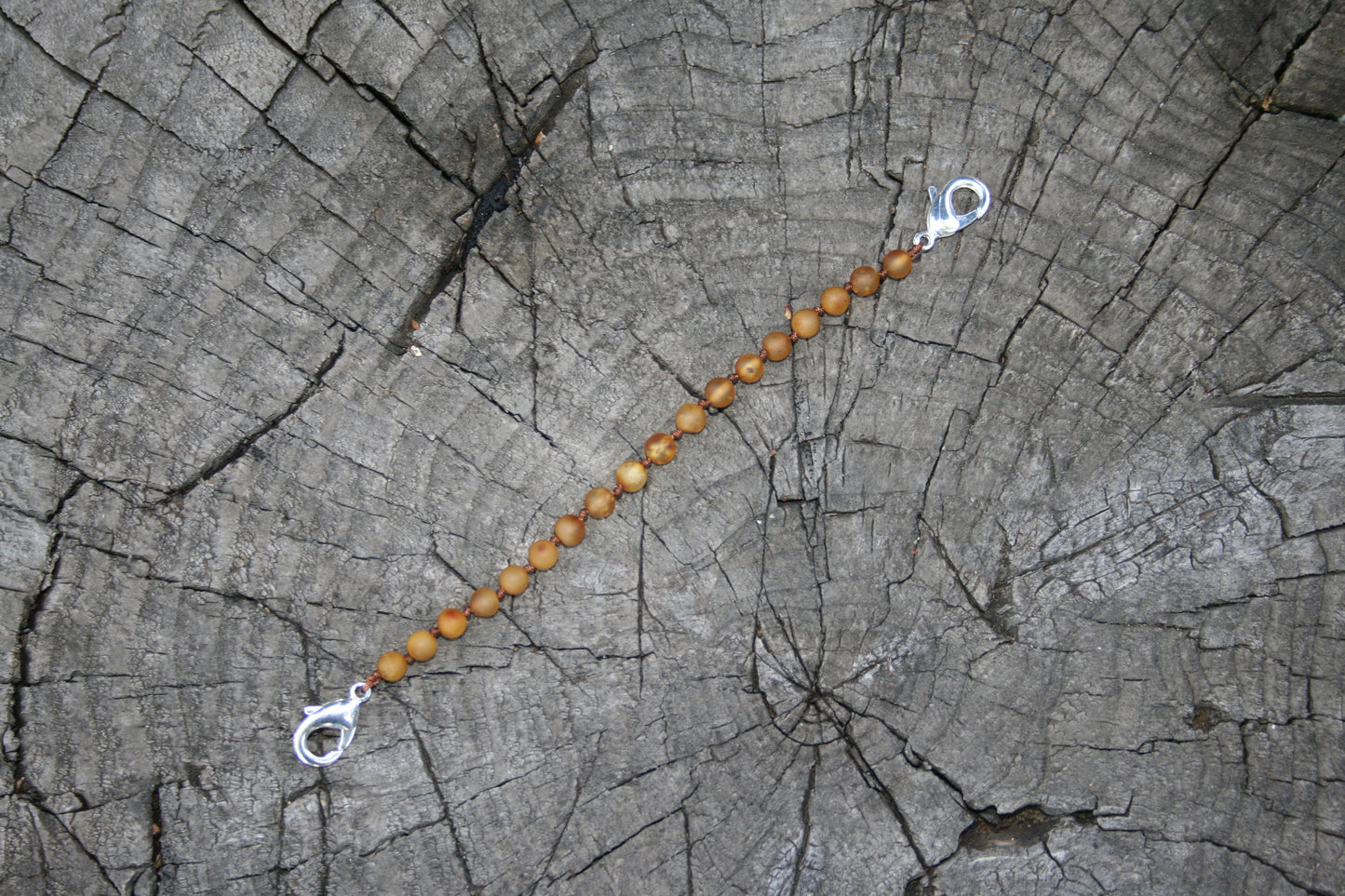 Picture is with honey colored amber(#3) -Baltic Amber Trach Chain, Healing Jewelry, Unpolished & Raw, Trach Strap, Trach Holder Media (baltic amber variation bracelet / necklace on wooden background)