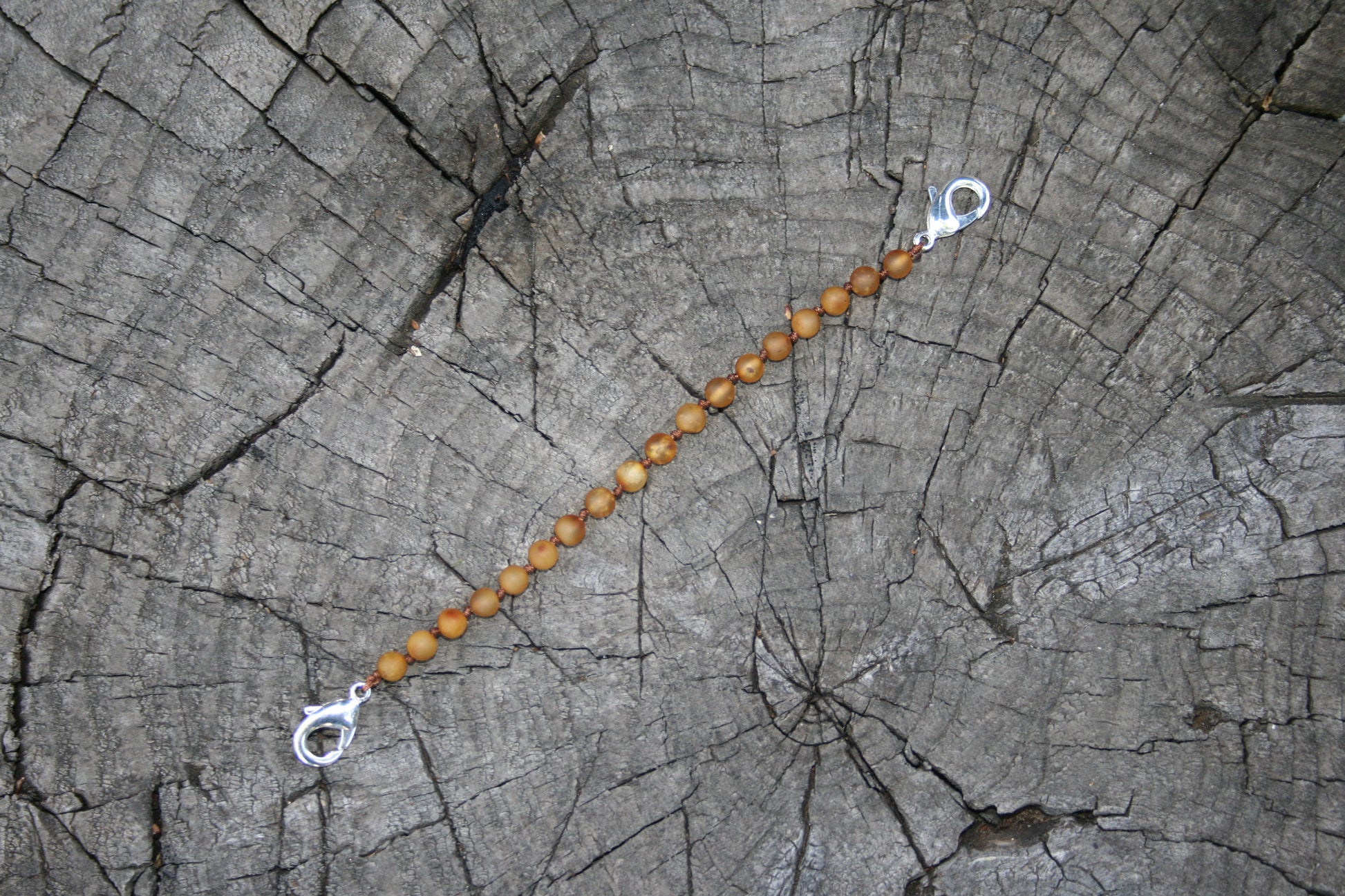 Picture is with honey colored amber(#3) -Baltic Amber Trach Chain, Healing Jewelry, Unpolished & Raw, Trach Strap, Trach Holder Media (baltic amber variation bracelet / necklace on wooden background)