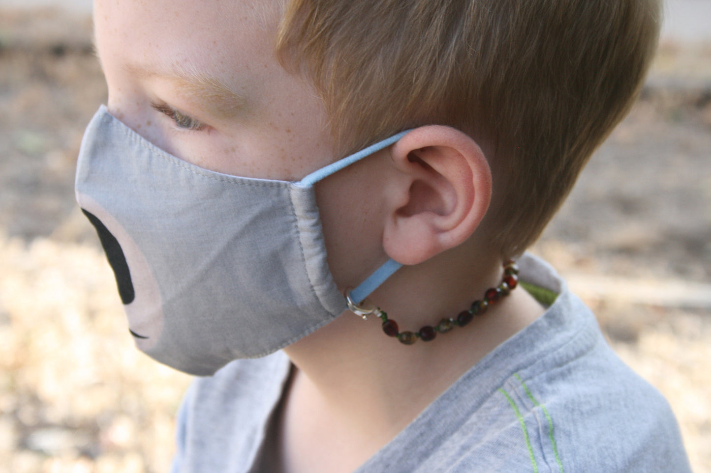 Picture of youth age boy with a mask chain/ glasses chain, you keep up with your glasses or your mask safe when you aren't wearing them. The lobster claw clasp can attach to a mask or hold any pair of glasses or sunglasses with the adjustable soft rubber clasp. For wearing Baltic amber , listing is for any length Mask Chain/ Glasses Chain you need and made with unpolished Baltic amber beads and nickel free, lead free, silver plated lobster clasps. Request a length or style not listed.