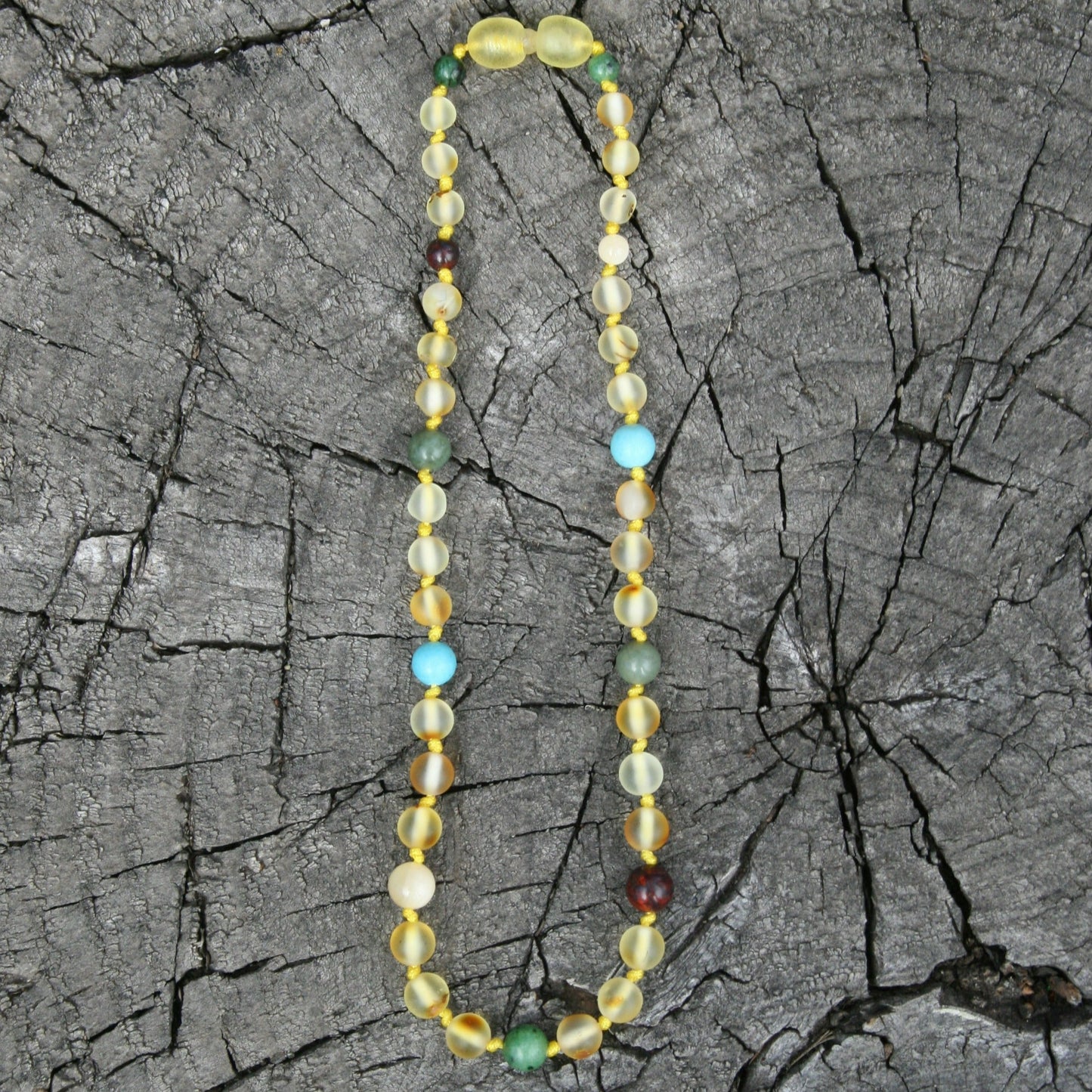 Acid Reflux Baltic Amber Teething Necklace, Bracelet, or Anklet- Raw & Unpolished (children and adult sizes) - necklace / bracelet on wooden background - amber variation