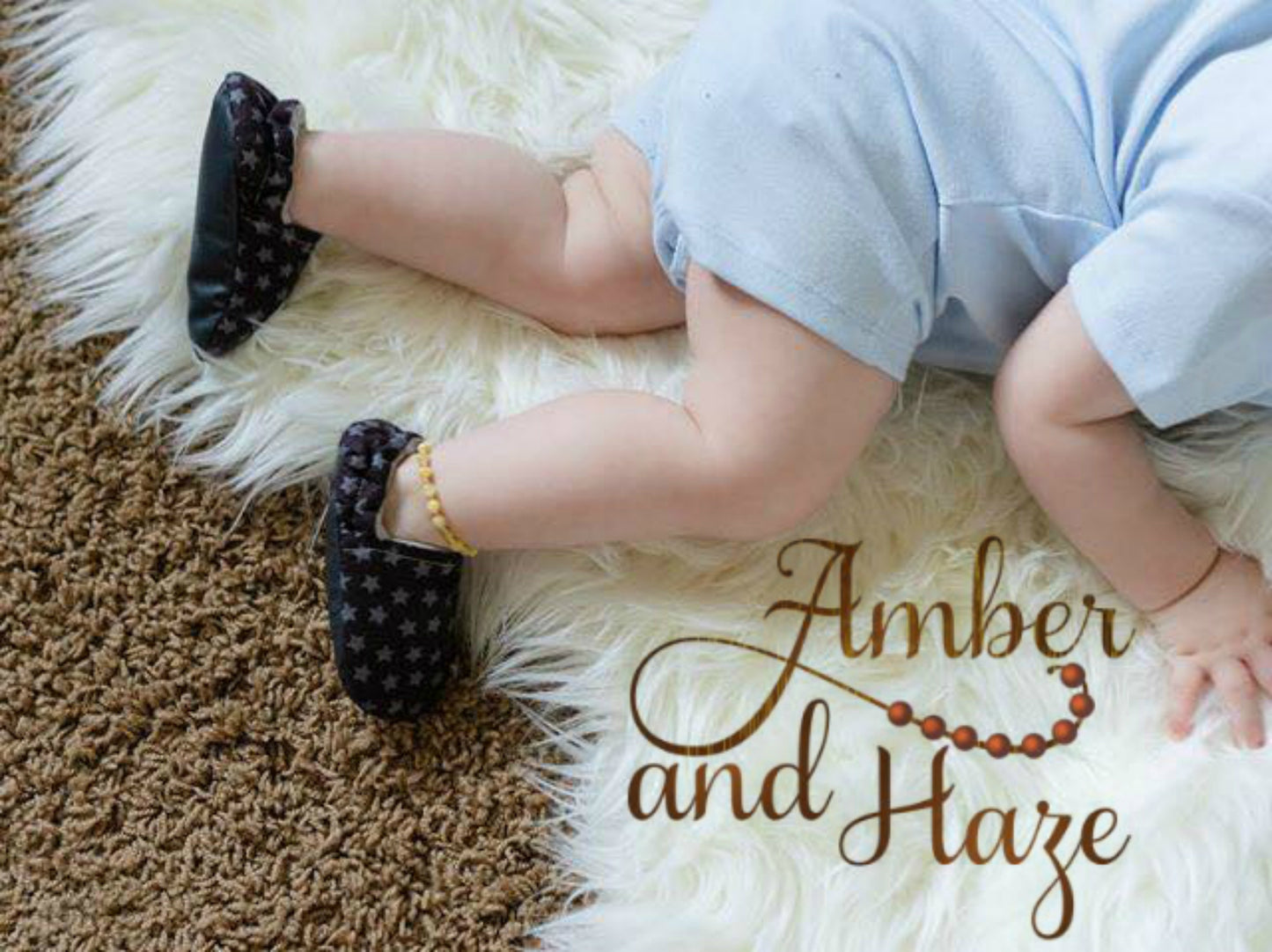 Picture of baby on white fur rug, with a baltic amber anklet.