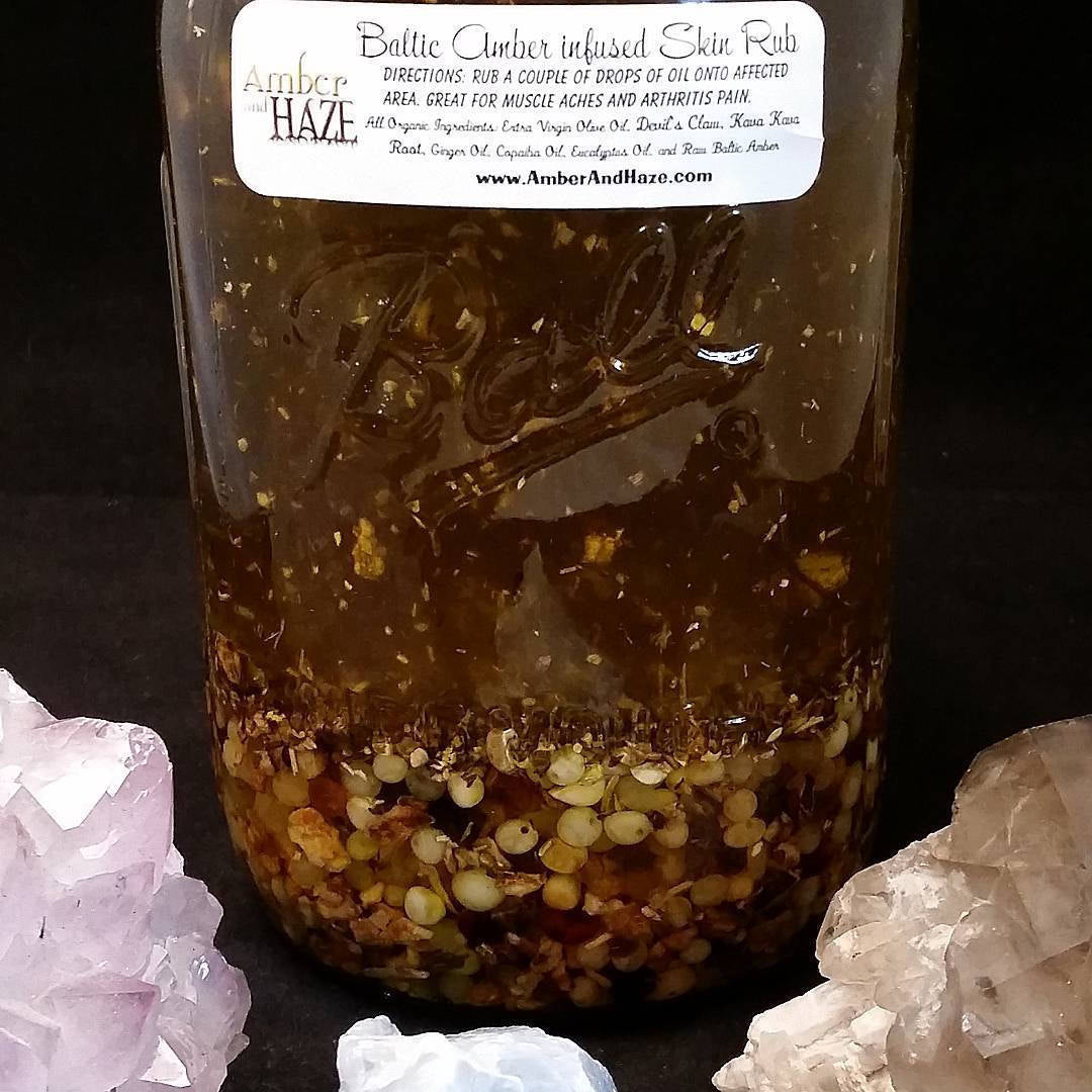 Photo ofBaltic Amber Infused Skin Rub - Magic In A Bottle ( black background, with crystals.)