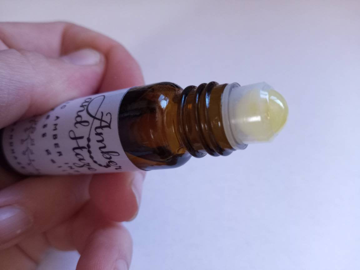 This listing is for any of our special essential oil blends in 10ml roller bottles with the Baltic amber roller ball. These roller balls are made out of 100% raw milky colored Baltic amber.  (model holder roller bottle)