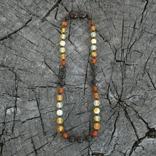 This listing is for any length of round sunset style Baltic amber jewelry starting at a 4" bracelet all of the way up to a 25" necklace. Longer options are available with our belly chain listing. Everything is strung on nylon cord and hand knotted between each bead. (Jewelry on wooden background)